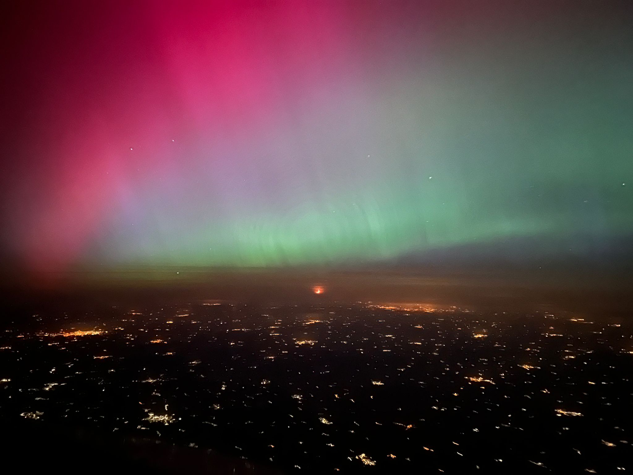 Aircraft flying under northern lights